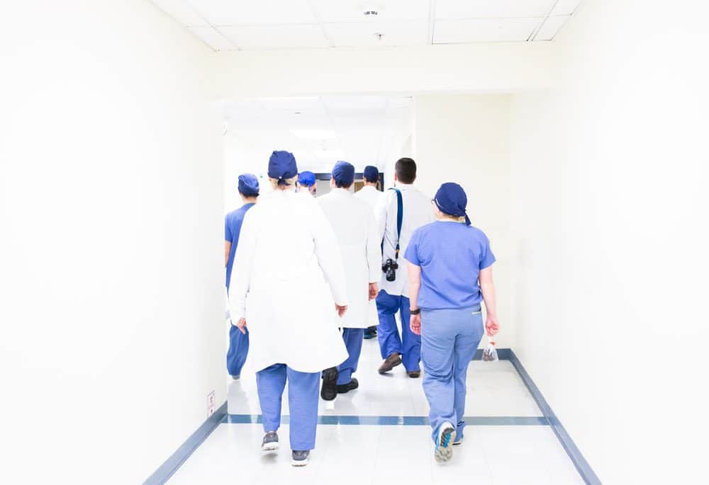 a group of doctors and nurses walking away