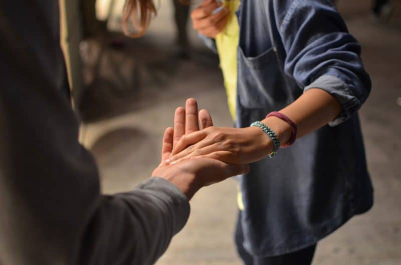 compassionate man helping a woman