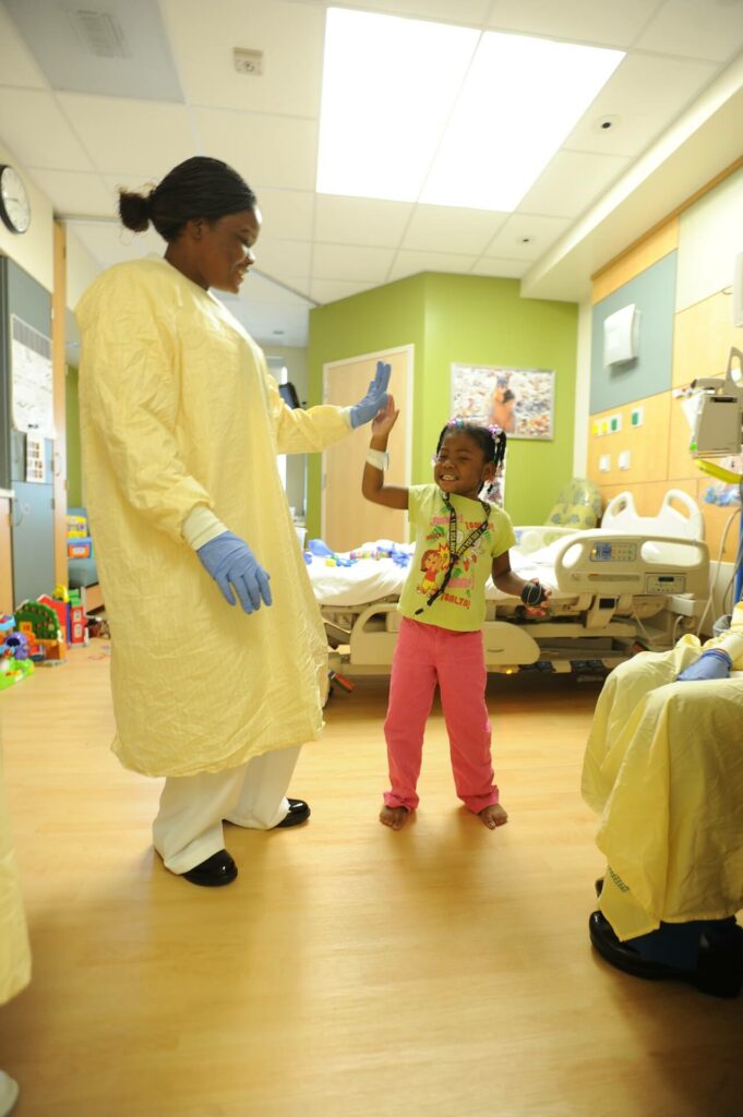 nurse giving high-five to a child